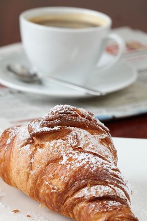 Croissant, coffee and newspaperの写真素材
