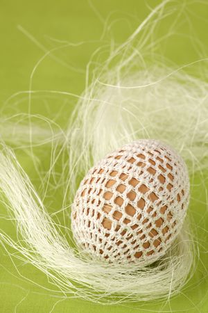 Easter egg with white crochet decorationの写真素材