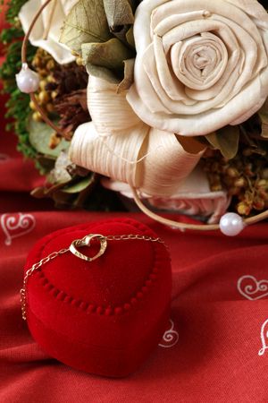 Golden necklace with heart and bouquetの写真素材