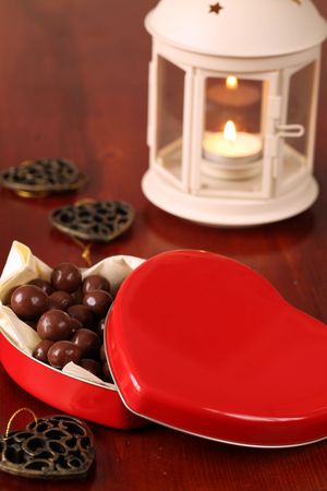 Heart shaped box with chocolate and lanternの写真素材