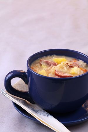 Czech cabbage soup made from sauerkraut with potato, carrot and meat sausageの写真素材