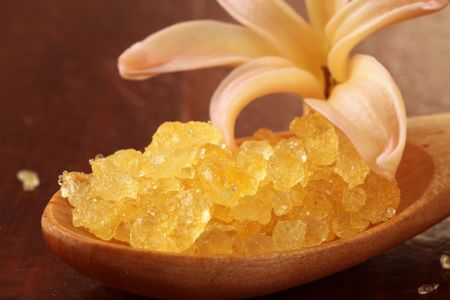 Yellow bath salt in a wooden spoon and hyacinthの写真素材