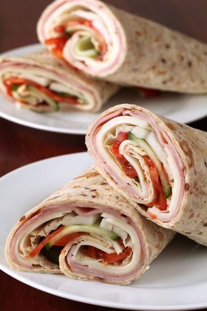 Wholemeal tortillas with ham, cheese, tomatoes, cucumber and cabbageの写真素材