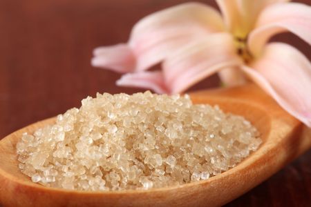 Cane sugar in a wooden spoonの写真素材