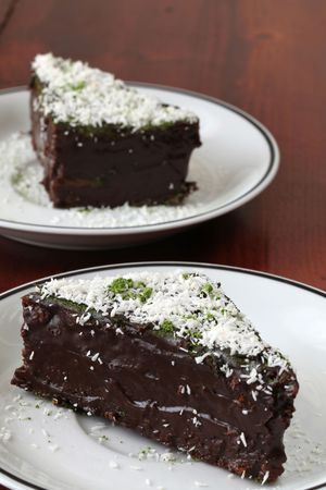 Chocolate cake garnished with coconut and Matcha green tea powderの写真素材