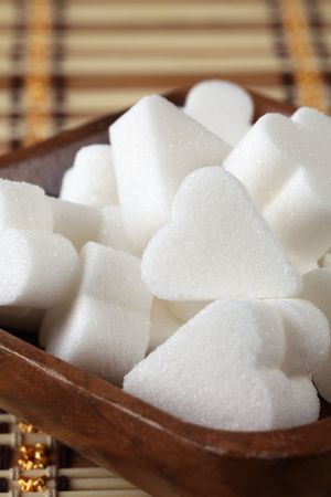 Bridge shape sugar cubes in a wooden bowlの写真素材