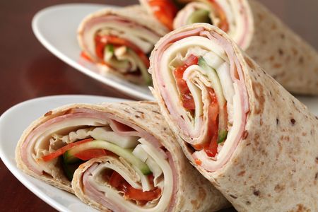 Wholemeal tortillas with ham, cheese, tomatoes, cucumber and cabbageの写真素材