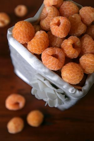 Box with fresh organic yellow raspberriesの写真素材