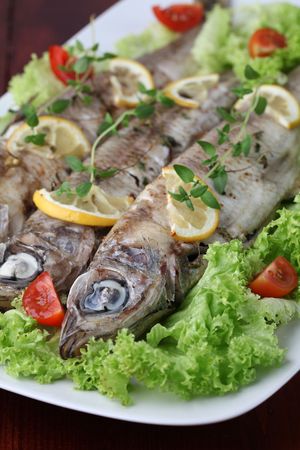 Baked trout with fresh lettuce and tomatoesの写真素材