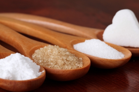 Wooden spoons with different kinds of sugarの写真素材