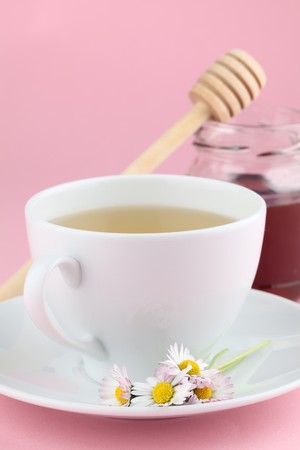 Herbal tea with daisies and honeyの写真素材