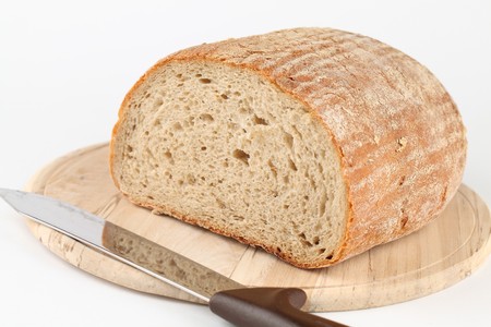 Loaf of fresh bread on cutting boardの写真素材