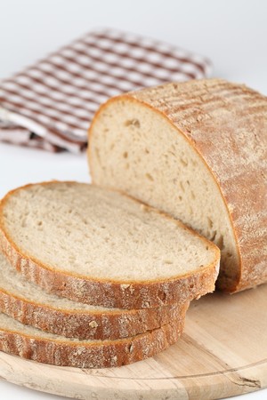 Loaf of fresh bread on cutting boardの写真素材