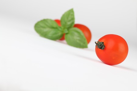 Cherry tomatoes and basilの写真素材