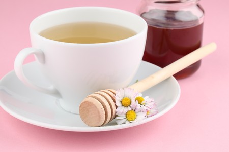 Herbal tea with daisies and honeyの写真素材