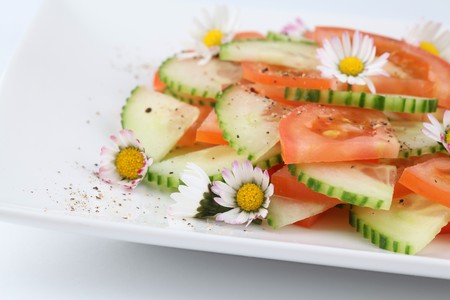 Spring salad with vegetables and daisiesの写真素材