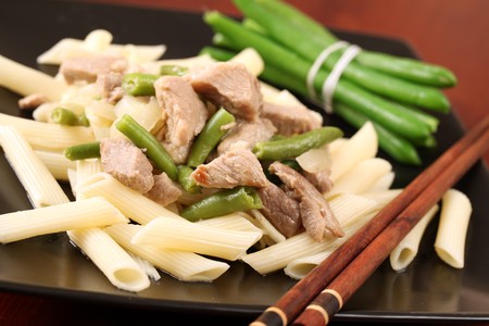 Penne rigate with pork, green beans and onionの写真素材