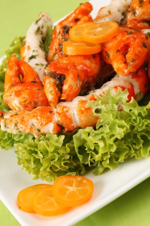 Shrimp and crab shaped surimi sticks with kumquats and lettuceの写真素材