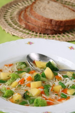 Vegetable soup with carrot, potato, broccoli, green beans, parsley and noodlesの写真素材