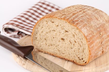 Loaf of fresh bread on cutting boardの写真素材