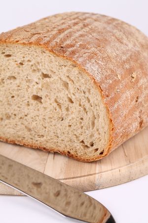 Loaf of fresh bread on cutting boardの写真素材