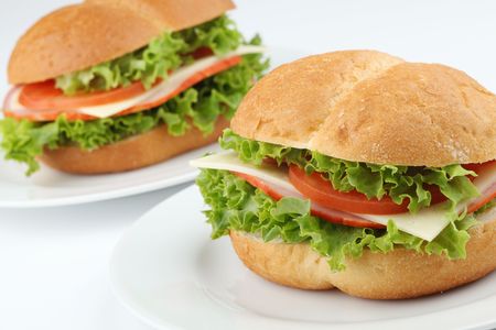 Ham and cheese sandwiches with tomatoes and lettuceの写真素材
