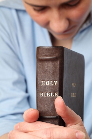 Young woman holding the Bible and prayingの写真素材