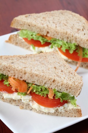 Vegetarian sandwiches with egg spread, lettuce, tomatoes and carrotsの写真素材