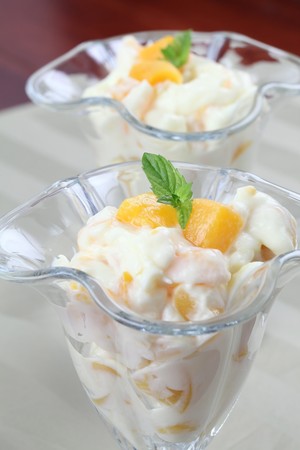 Yogurt dessert with peachesの写真素材