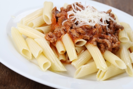Penne pasta with bolognese sauce and cheeseの写真素材