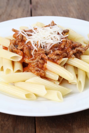 Penne pasta with bolognese sauce and cheeseの写真素材