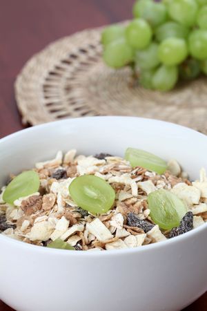 Granola with dried fruits garnished with fresh grapesの写真素材