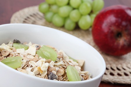 Granola with dried fruits garnished with fresh grapesの写真素材