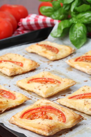 Puff pastry with cheese and tomatoes seasoned with sesame seedsの写真素材
