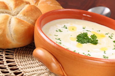 Vegetable cream soup made of carrot, potato, broccoli, green beans, parsley and creamの写真素材