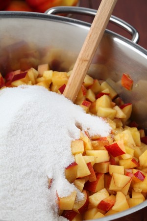 Chopped nectarines and sugar in a pot to make a delicious jamの写真素材
