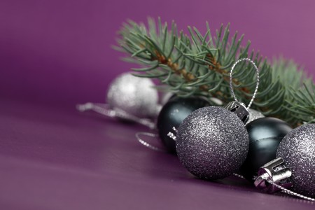 Silver Christmas ornaments on purple background. Copy spaceの写真素材