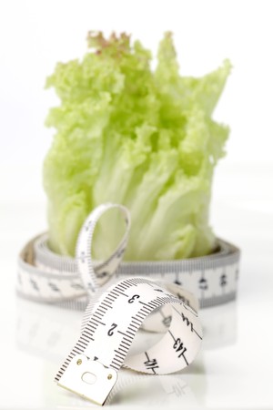 Tape measure and lettuce. Focus on tape measureの写真素材