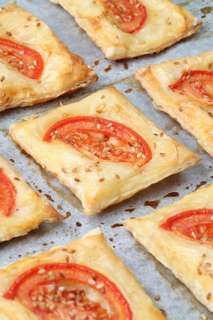 Puff pastry with cheese and tomatoes seasoned with sesame seedsの写真素材
