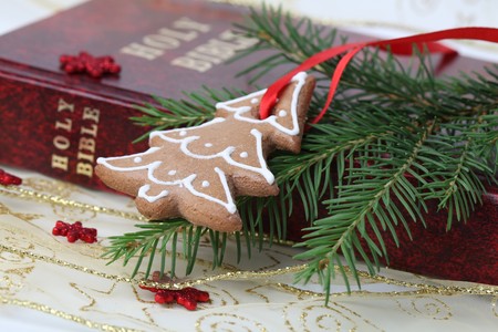 Gingerbread cookie in the shape of Christmas tree on the Bibleの写真素材
