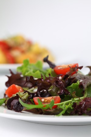 Mixed greens with cherry tomatoes sprinkled with sesame seeds. Shallow DOFの写真素材
