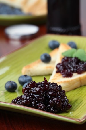 Blueberry jam with toasts and fresh blueberries on a plate. Shallow dofの写真素材