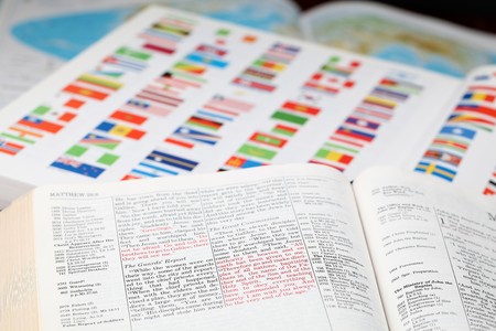 Open Bible with selective focus on the text in Matthew 25 - Great Commission. Jesus is sending and commissioning his disciples to continue His work. World missions concept.の写真素材