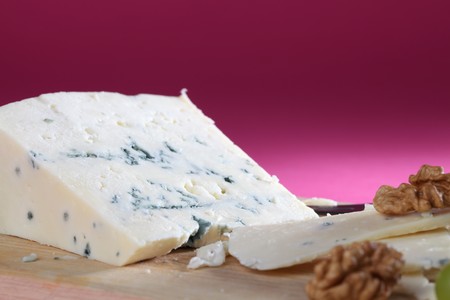 Blue cheese on cutting board with walnuts and grapesの写真素材