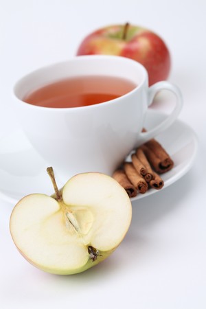Apple tea with cinnamon on white background. Shallow dofの写真素材