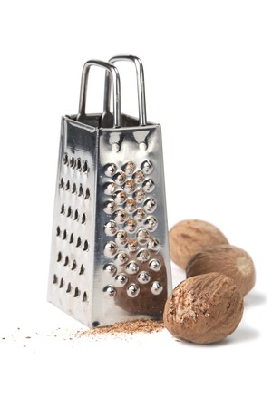 Nutmegs and grater isolated on white background. Shallow dofの写真素材