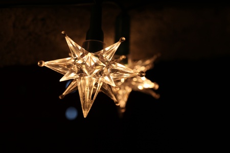 Star shaped Christmas lights on dark background. Shallow dof, copy space.の写真素材
