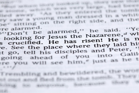 Open Bible with selective focus on text in Mark 16:6 about Jesus' resurrection. Shallow DOFの写真素材