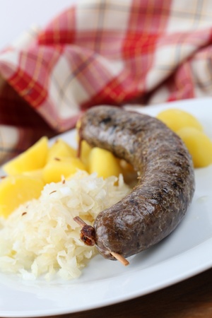 Traditional Czech white pudding made of pork, groats and various spices with potatoes and sauerkrautの写真素材