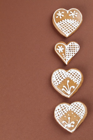 Gingerbread hearts on brown backgroundの写真素材